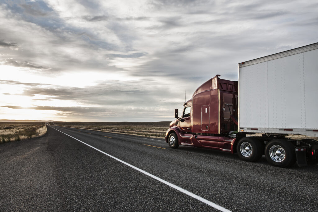 Side view of the cab of a commercial truck on the highway in eastern Washington, USA.